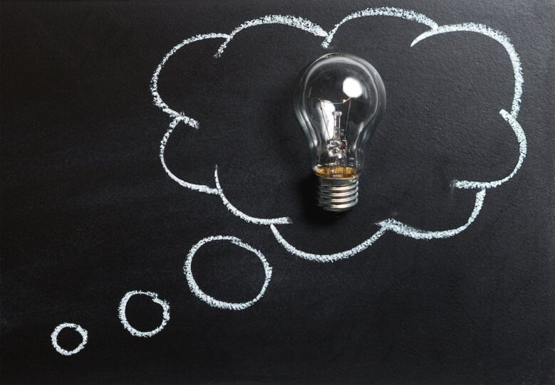 Light bulb inside thinking cloud.
