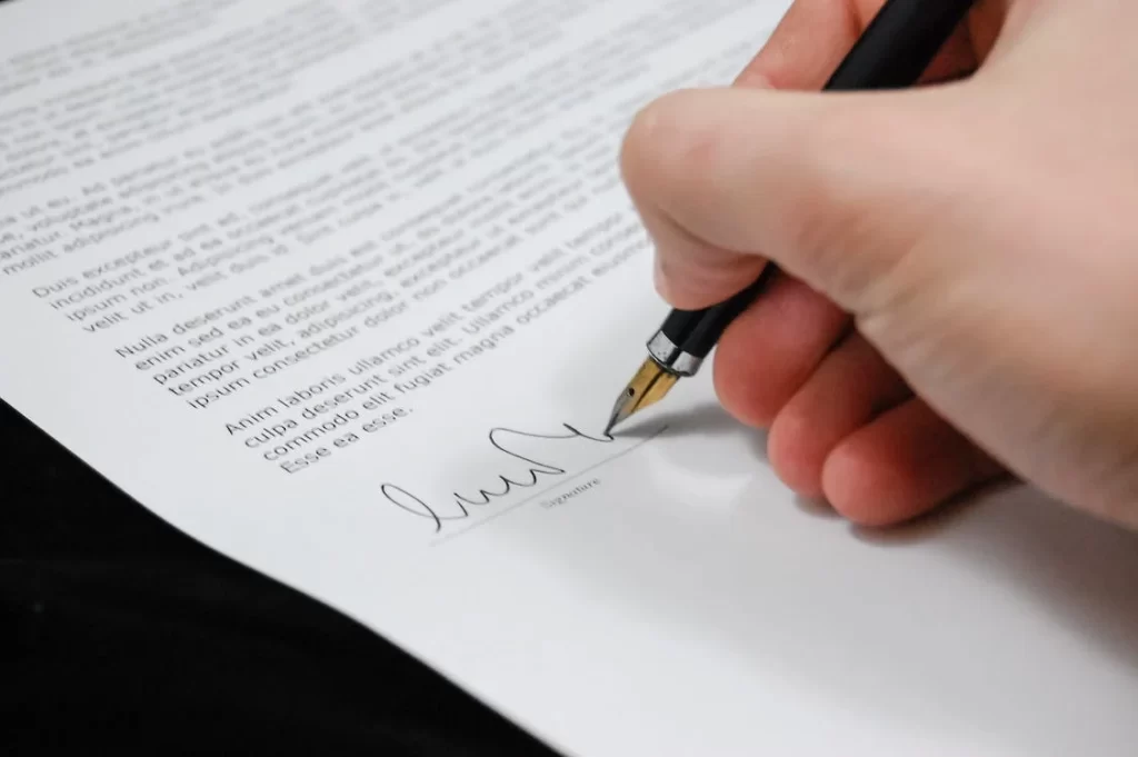 Hand signing a contract