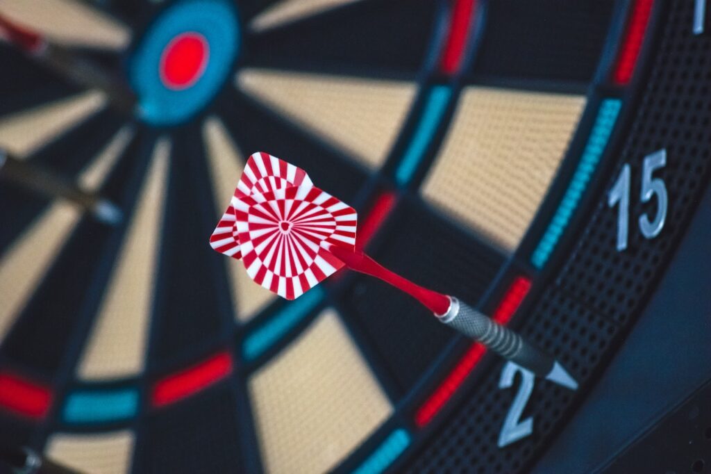 dartboard focused on a red dart on the outer rim on the number 2.