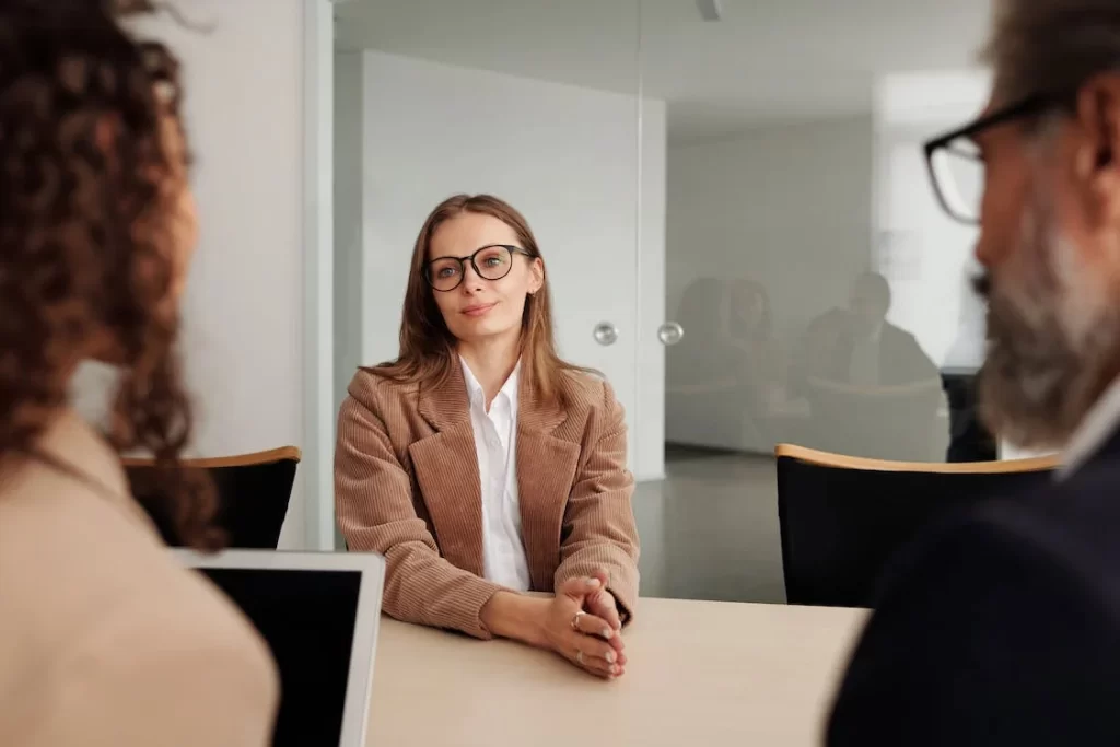 Woman in an interview with 2 other people.