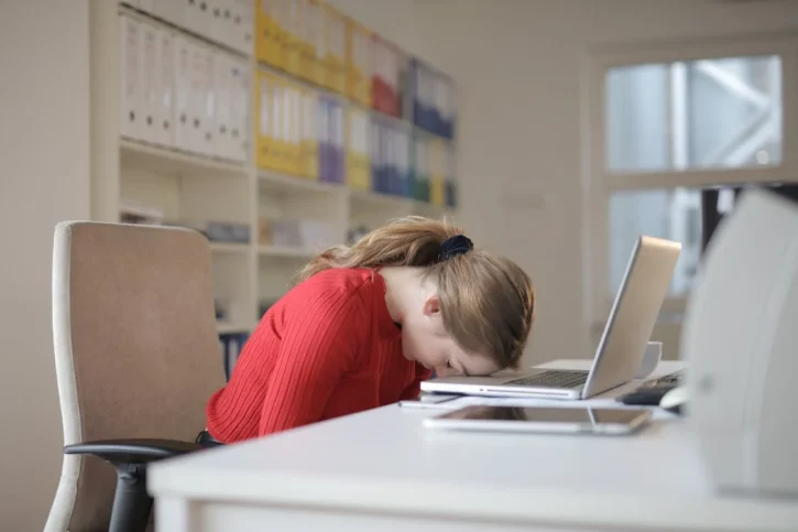 Woman face down on her laptop.