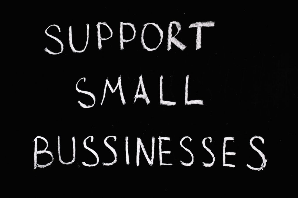 Black background with white letters spelling support small business