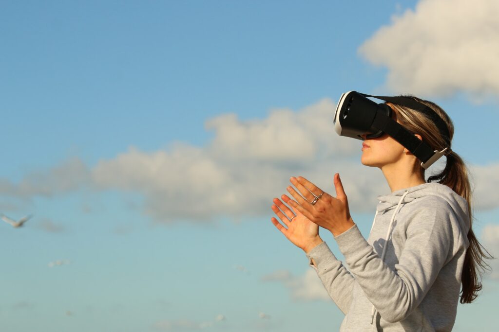 woman with arms stretched out while wearing a virtual reality headset