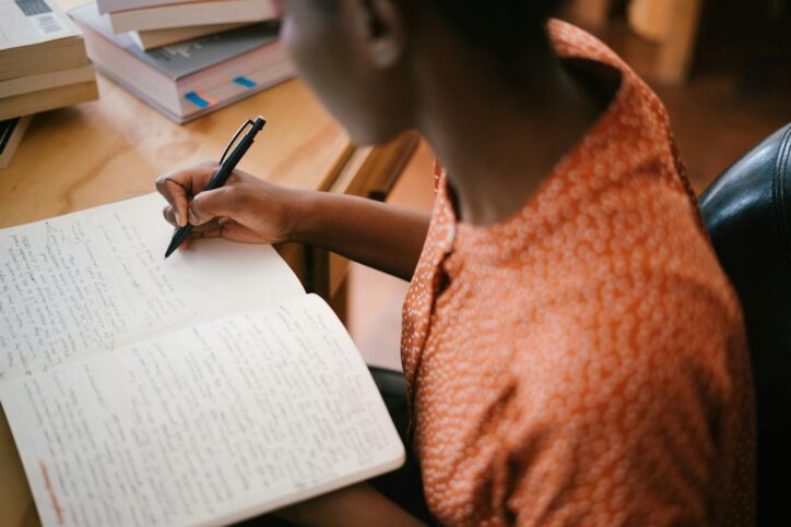 Woman writing in her journal.