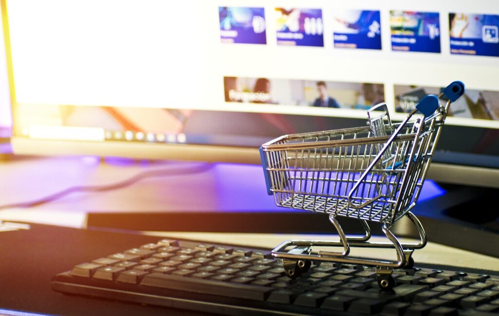 A miniature shopping cart on a keyboard.