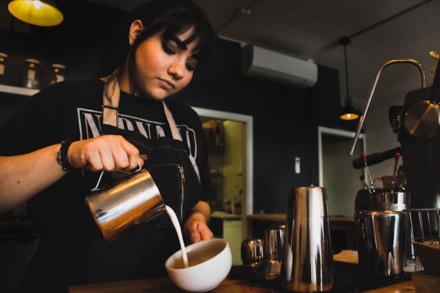 Barista pouring coffee. Goods and services, coffee and barista. 