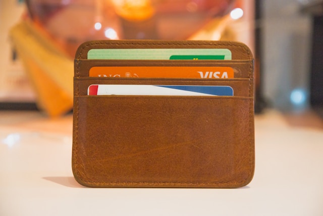 Image of wallet with a Visa card and several others used to save money.