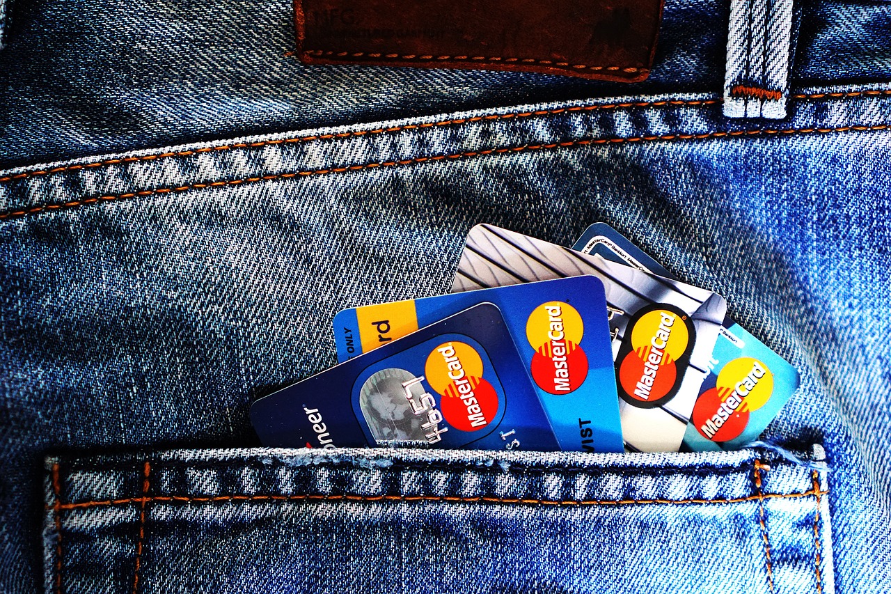 Four credit cards in someone's jean pocket.