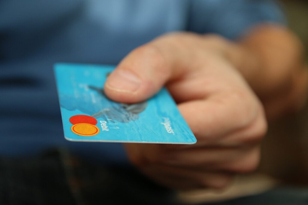 A person handing a credit card.