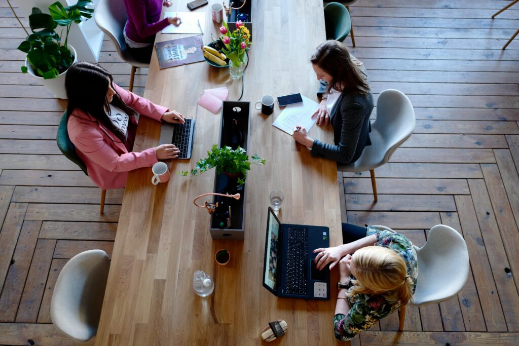Three women sitting at an office table